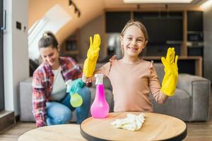 Happy daughter and mother cleaning house together photo