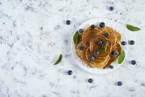 Pancakes with honey and blueberries. Sweet homemade pancakes photo