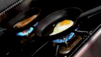 Spin zoom in on frying egg in a pan on the stove video