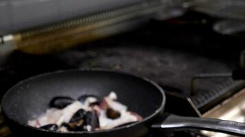 Zoom in shot of frying shrimps and other seafood in a pan video