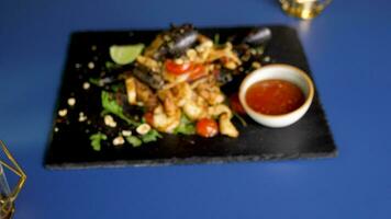 Zoom in on delicious and healthy plateau with cooked seafood on restaurant table video