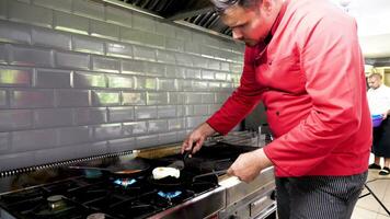 Cook frying eggs on a pan in restaurant kitchen video