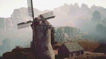 Countryside landscape with old windmill photo