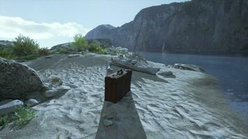 A piece of luggage sitting on top of a sandy beach photo