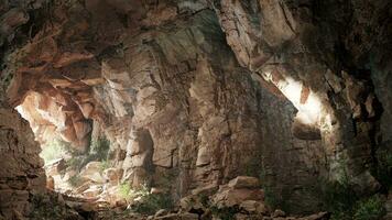 A cave with a light coming from it photo