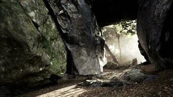 Shaft of light beaming down into large cave photo