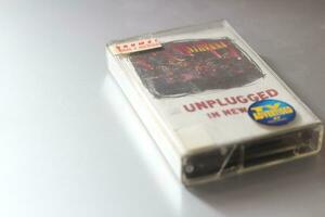 Bangkok, Thailand - 09 February 2022  Nirvana Albums 90s cassette tape unplugged in new york on gray background. photo