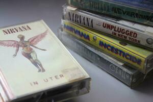 Bangkok, Thailand - february ,09 2022  90's cassette tapes of Nirvana Albums Incesticide, Nevermind, Bleach, From The Muddy Banks of The Wishkah, Unplugged in New York on a gray floor. photo