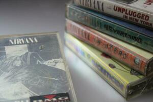 Bangkok, Thailand - february ,09 2022  90's cassette tapes of Nirvana Albums Incesticide, Nevermind, Bleach, From The Muddy Banks of The Wishkah, Unplugged in New York on a gray floor. photo