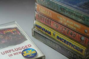 Bangkok, Thailand - february ,09 2022  90's cassette tapes of Nirvana Albums Incesticide, Nevermind, Bleach, From The Muddy Banks of The Wishkah, Unplugged in New York on a gray floor. photo