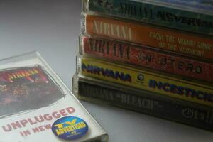 Bangkok, Thailand - february ,09 2022  90's cassette tapes of Nirvana Albums Incesticide, Nevermind, Bleach, From The Muddy Banks of The Wishkah, Unplugged in New York on a gray floor. photo