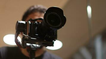 Cameraman holding a DSLR camera video