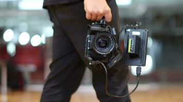 Cameraman holding a DSLR camera video