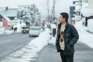 man tourist sightseeing in Niseko city with Snow in winter season. landmark and popular for attractions in Hokkaido, Japan. Travel and Vacation concept photo