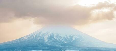 Beautiful Yotei Mountain with Snow in winter season at Niseko. landmark and popular for Ski and Snowboarding tourists attractions in Hokkaido, Japan. Travel and Vacation concept photo