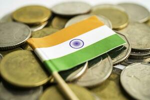 Stack of coins with India flag and US dollar banknotes. photo