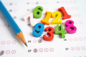 Math number and pencil on answer sheet paper, Education study testing learning teach concept. photo