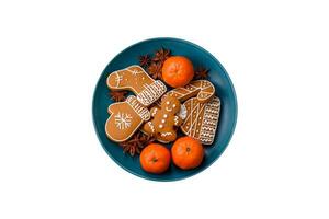 Beautiful festive Christmas composition of tangerines, gingerbread and star anise photo