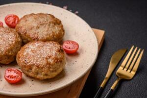 Delicious fresh fried minced fish cutlets with spices and herbs photo