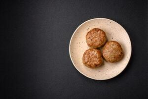 Delicious fresh fried minced fish cutlets with spices and herbs photo