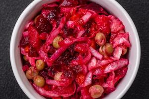 Delicious juicy vinigret salad of boiled vegetables potatoes, beets, pot, cabbage and carrots photo