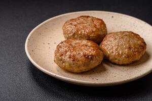 Delicious fresh fried minced fish cutlets with spices and herbs photo