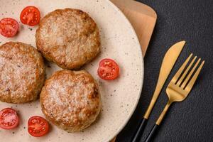 Delicious fresh fried minced fish cutlets with spices and herbs photo