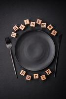 Christmas party inscription with wooden cubes on a dark concrete background photo