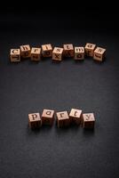 Christmas party inscription with wooden cubes on a dark concrete background photo