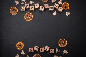 Christmas party inscription with wooden cubes on a dark concrete background photo