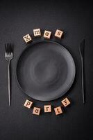 Christmas party inscription with wooden cubes on a dark concrete background photo