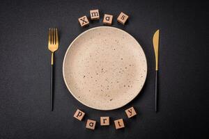 Christmas party inscription with wooden cubes on a dark concrete background photo