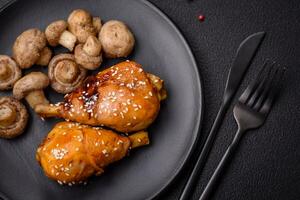 Delicious Asian dish with chicken legs in teriyaki sauce with salt and spices photo