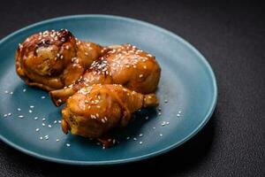 Delicious Asian dish with chicken legs in teriyaki sauce with salt and spices photo