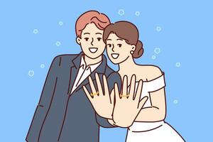 Marriage ceremony of man and woman, with wide smile showing wedding rings on fingers. Loving couple of guy and girl experience romantic feelings, pose after registering wedding or family union vector