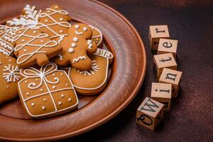 Beautiful delicious sweet winter Christmas gingerbread cookies on a bronze textured background photo