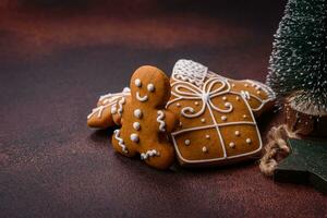 Beautiful delicious sweet winter Christmas gingerbread cookies on a bronze textured background photo