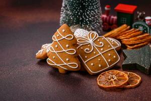 Beautiful delicious sweet winter Christmas gingerbread cookies on a bronze textured background photo