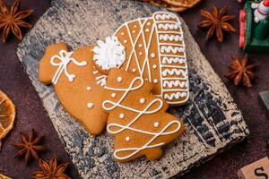 Beautiful delicious sweet winter Christmas gingerbread cookies on a bronze textured background photo