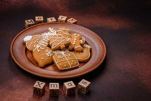 Beautiful delicious sweet winter Christmas gingerbread cookies on a bronze textured background photo