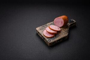 Delicious smoked sausage with salt and spices cut into slices photo