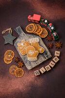 Beautiful delicious sweet winter Christmas gingerbread cookies on a bronze textured background photo