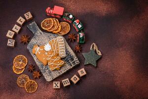 Beautiful delicious sweet winter Christmas gingerbread cookies on a bronze textured background photo