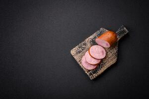 Delicious smoked sausage with salt and spices cut into slices photo