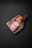 Delicious smoked sausage with salt and spices cut into slices photo