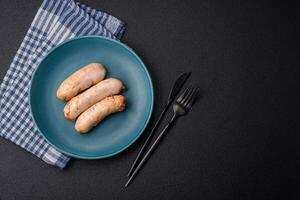 Delicious grilled chicken or pork sausages with salt, spices and herbs photo