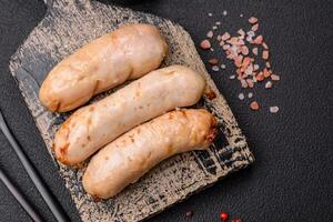 Delicious grilled chicken or pork sausages with salt, spices and herbs photo