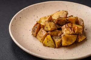 Delicious crispy fried potato wedges with salt, spices and herbs photo