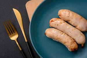 Delicious grilled chicken or pork sausages with salt, spices and herbs photo