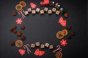 Christmas party inscription with wooden cubes on a dark concrete background photo